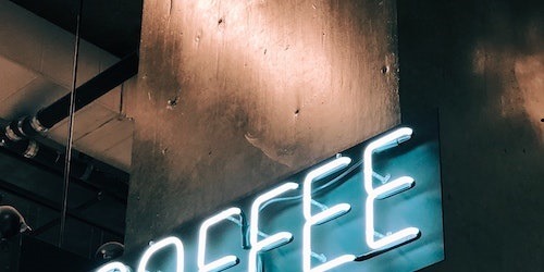 Barista preparing coffee in a busy café