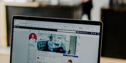 Marketing team collaborating around sticky notes and laptops